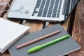 Pencil with pen on a close notebook and laptop on wood table. Se Royalty Free Stock Photo