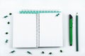 Pencil and pen in green, open notebook, stationery isolated on white background Royalty Free Stock Photo