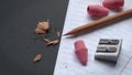 Pencil and Pencil Sharpener and Pink Erasers on Notepad Paper Royalty Free Stock Photo