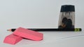 A pencil, pencil sharpener and two pink erasers Royalty Free Stock Photo