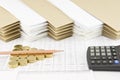 Pencil on pile of gold coins with calculator Royalty Free Stock Photo