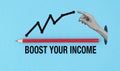 A pencil is pointing to a graph that says Boost Your Income. The pencil is red and the graph is blue. Royalty Free Stock Photo