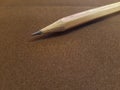 Pencil resting on a brown cloth