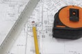 Pencil, scale, and tape measure on plans