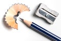 pencil sharpener, pencil and shavings on white desk Royalty Free Stock Photo