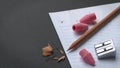 Pencil and Pencil Sharpener and Pink Erasers on Notepad Paper Royalty Free Stock Photo