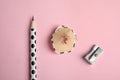 Pencil, sharpener and shaving on pink background Royalty Free Stock Photo