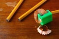 Pencil in a sharpener and two unsharpened pencils Royalty Free Stock Photo