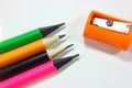 Pencil sharpeners and colored pencils in a pile Royalty Free Stock Photo