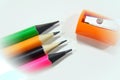 Pencil sharpeners and colored pencils in a pile Royalty Free Stock Photo