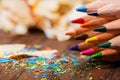 Pencil shavings and colored pencils on the wooden table