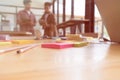 pencil and sticky note on table with background of young university students studying with tablet doing group study for school as Royalty Free Stock Photo