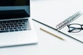 Pencil, textbook with eyeglasses and laptop