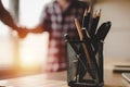 Pencil and tools in pen holder stand on desk Royalty Free Stock Photo