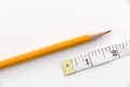 Pencil and two inches of measuring tape Royalty Free Stock Photo