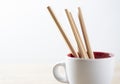 Pencil on the white coffee cup on the white background Royalty Free Stock Photo