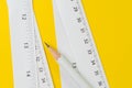 Pencil and white measuring tapes with centimetre and inches on v Royalty Free Stock Photo