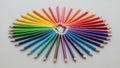 Pencils are arranged in a circular pattern on a smooth light gray Royalty Free Stock Photo