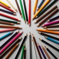 Pencils arranged radially on a white surface create a circular Royalty Free Stock Photo