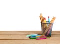 Pencils in basket container and colorful crayons on wooden table Royalty Free Stock Photo