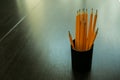 Pencils in a black plastic pencil case on a wooden table. Royalty Free Stock Photo