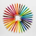 Pencils and caps are arranged in a circular pattern on a white back Royalty Free Stock Photo