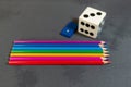 Pencils with dice and domino on a grey background.Flag of the Italian peace organization PACE