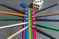 Pencils with dice and domino on a grey background.Flag of the Italian peace organization PACE