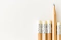 Pencils with eraser side up, onewith tip standing out, on white background with copy-space.Pencils with eraser side up, onewith ti Royalty Free Stock Photo