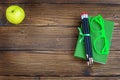 Pencils and glasses, a book and an apple on a wooden background. Royalty Free Stock Photo