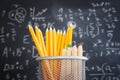 Pencils infront of blackboard with formulas. education concept Royalty Free Stock Photo