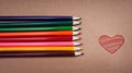 Pencils lie on a cardboard surface