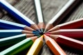 Pencils lie in a circle on a wooden table Royalty Free Stock Photo