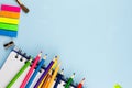 Pencils lie on a notebook on a blue background. Royalty Free Stock Photo