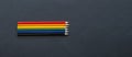 Pencils lie on top Bright social colors lgbt. LGBT colors corrugated cardboard flag
