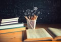 Pencils and Open books with formulas on the chalkboard .education concept Royalty Free Stock Photo