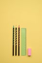 Pencils, ruler and rubber on yellow background, flatlay. Back to school