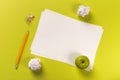 Pencils with sharpening shavings with white paper sheets on coloured backgroung, Office tool, green apple, rolled paper