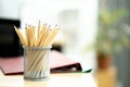 Pencils stand on a wooden table in a ray of sunlight.Office with shallow dof and copyspace