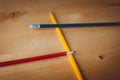 Pencils on table in the colours yellow, red and blue