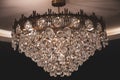 Pendant chandelier with sparkling crystal on dark background. Vintage shiny luster lamp closeup. Luxury interior decoration. Royalty Free Stock Photo