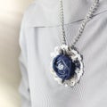 Pendant in the form of a flower of denim as a stylish accessory of a woman Royalty Free Stock Photo