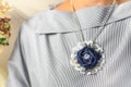 Pendant handmade in the form of a flower of denim as a stylish accessory of a woman Royalty Free Stock Photo