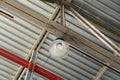 Pendant light on metal trusses covering an industrial long-span building