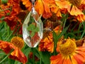 Pendant made of epoxy resin with clover on a background of flowers Royalty Free Stock Photo