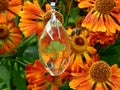 Pendant made of epoxy resin with clover on a background of flowers Royalty Free Stock Photo