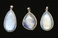 Pendants made of rainbow moonstone behind a black surface Royalty Free Stock Photo