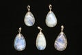Pendants made of rainbow moonstone behind a black surface Royalty Free Stock Photo