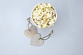 Pendants and popcorn in striped cup