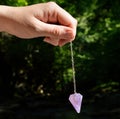 Pendulum dowser with amethyst Royalty Free Stock Photo